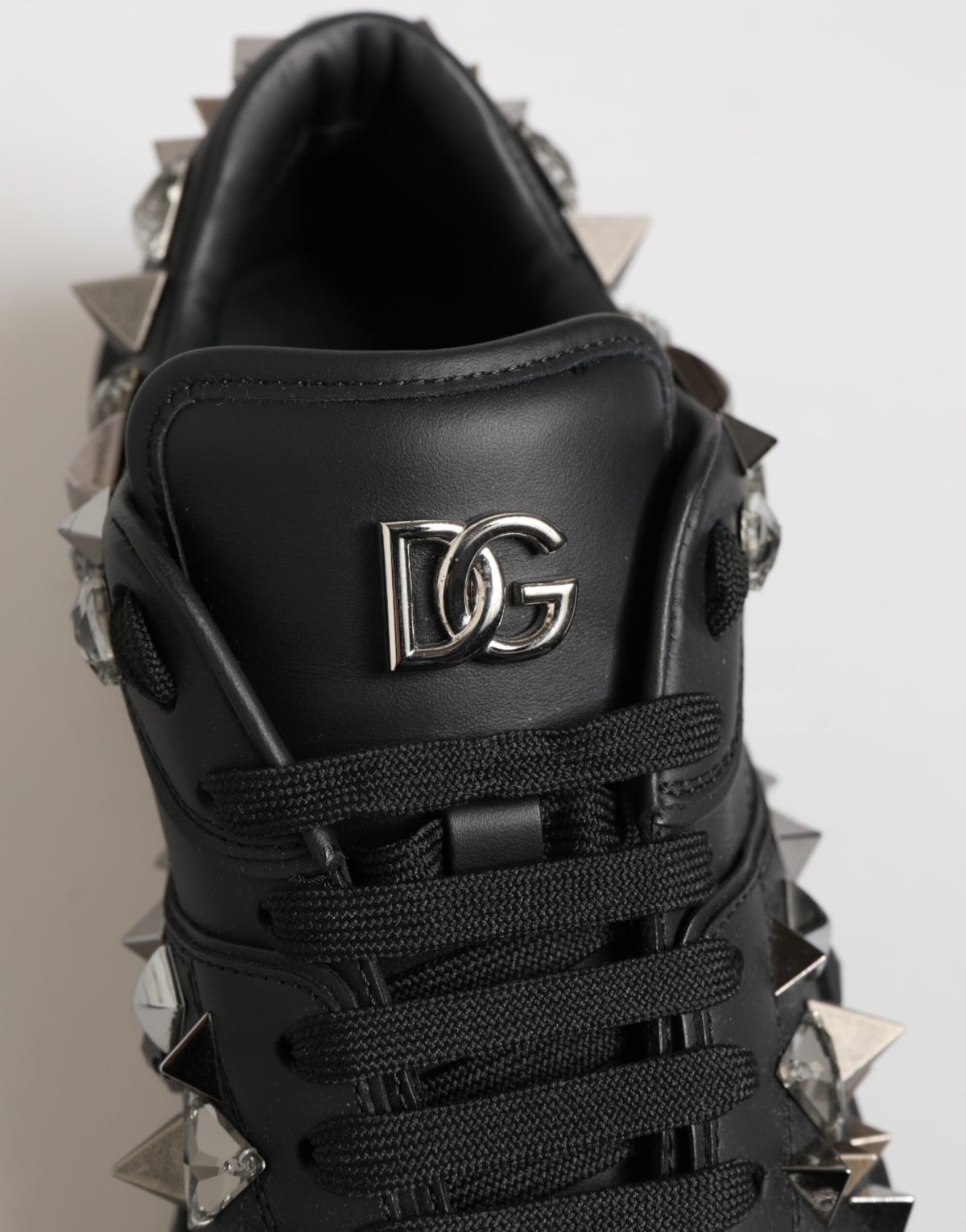 Indulge in the exquisite Dolce & Gabbana Black Leather Studded Low Top Sneakers, where unparalleled craftsmanship meets luxurious design for effortless elegance.
