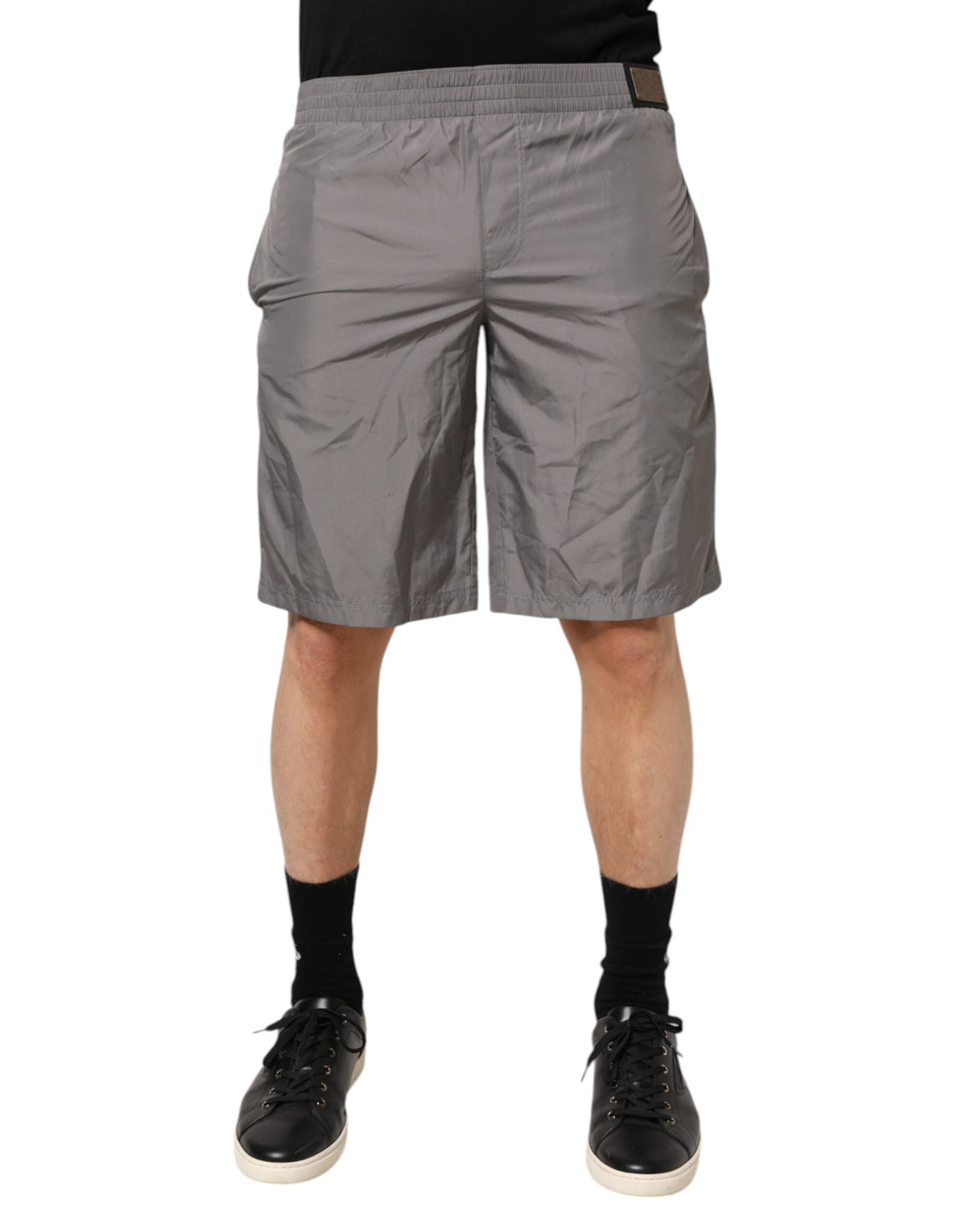 Indulge in the elegance of Dolce & Gabbana's Light Gray Nylon Elastic Waist Shorts, crafted in Italy for a sophisticated beachside allure that embodies luxury and timeless style.