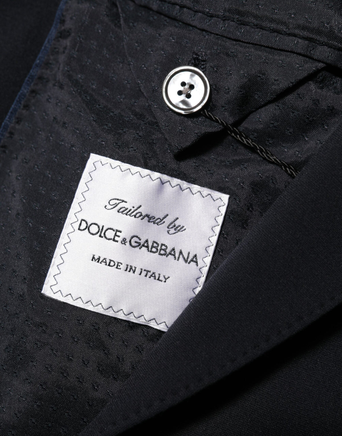 Elevate your wardrobe with the Dolce & Gabbana Black Viscose 2 Buttons Suit Jacket Blazer, a masterpiece of Italian craftsmanship that embodies timeless elegance and sophisticated allure.