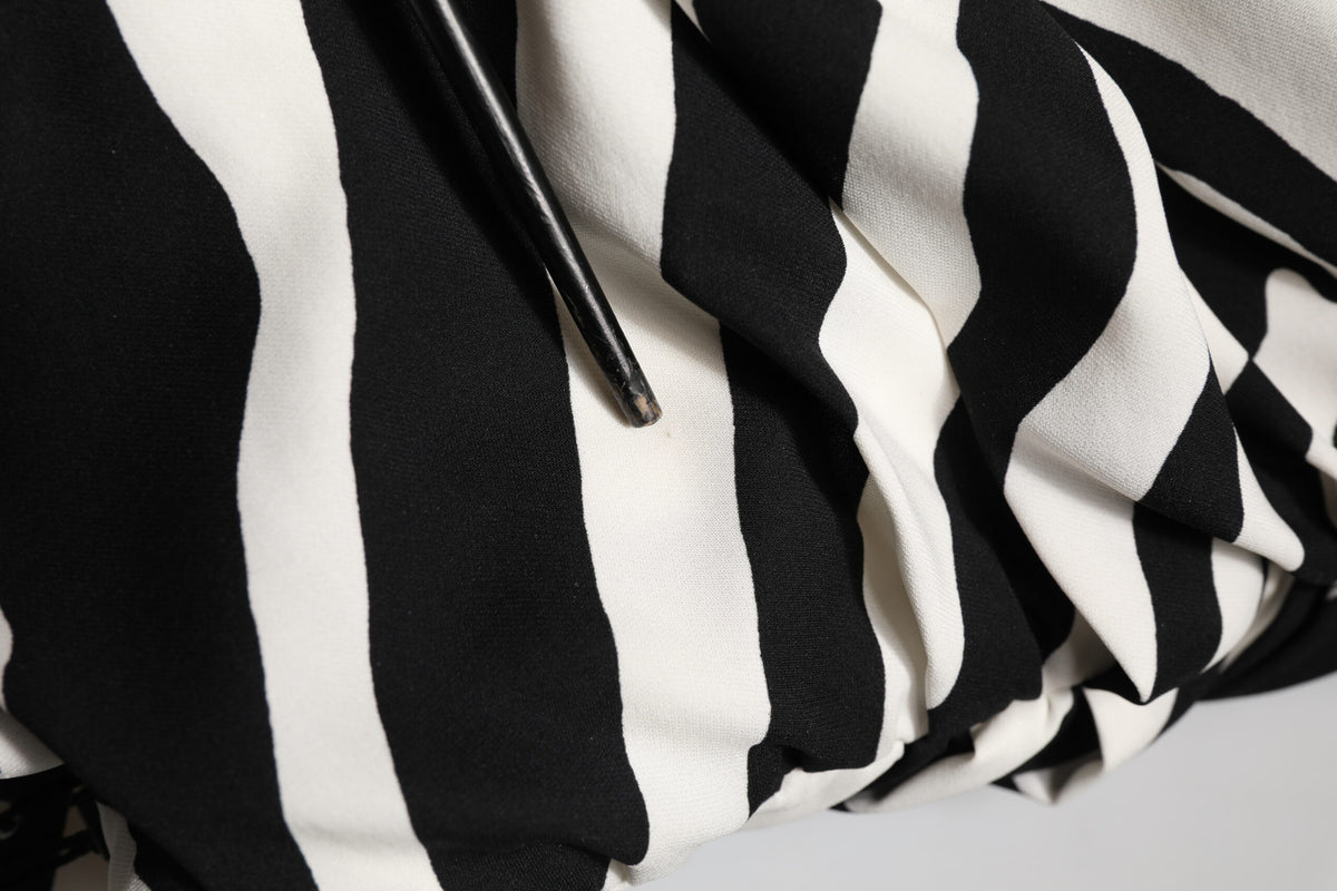 Indulge in the exquisite Dolce & Gabbana Black White Zebra Silk Sheath Mini Dress, where luxurious silk meets bold elegance, perfect for any sophisticated occasion.